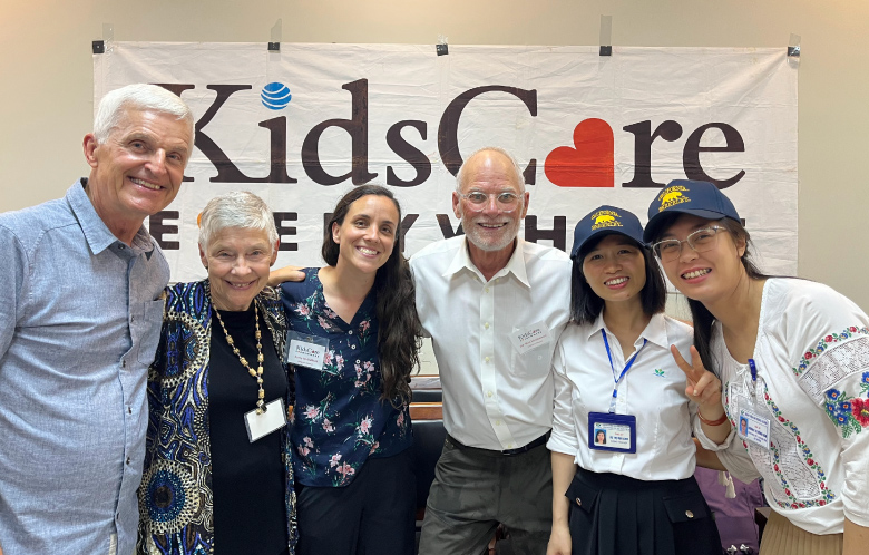 Members of the Kids Care Everywhere Foundation gathered for a picture at a conference