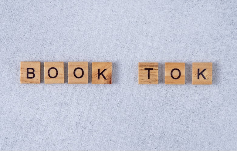 BOOK TOK spelled out with scrabble pieces