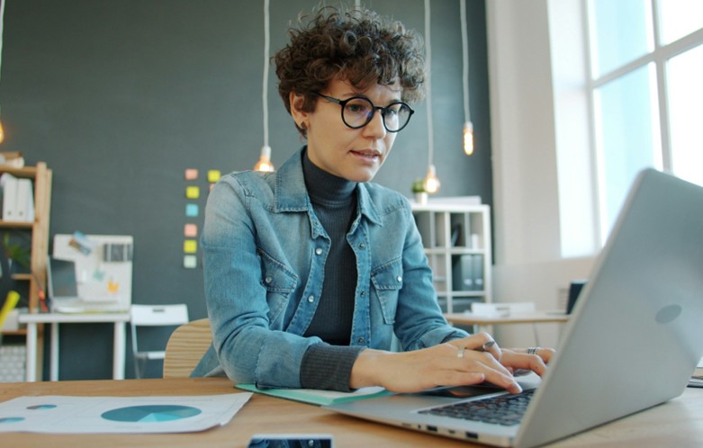 Professional woman working on a laptop in her office