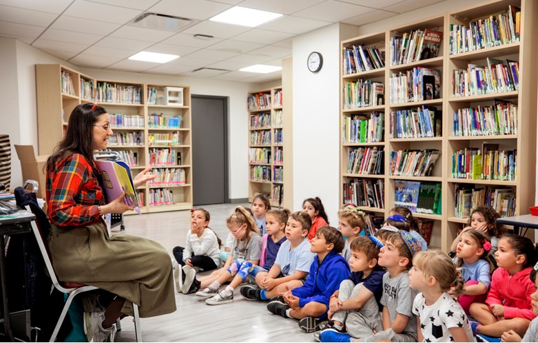 teacher reading to a classroom of toddlers
