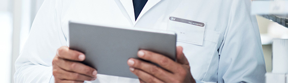 Close up of male physician holding tablet
