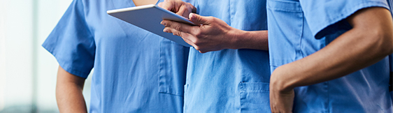Close up of three nurses on tablet