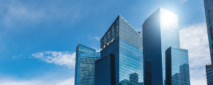 Modern glass skyscrapers against a blue sky