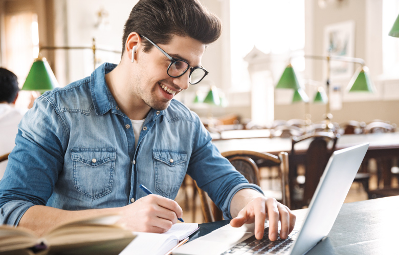 Male researching on laptop
