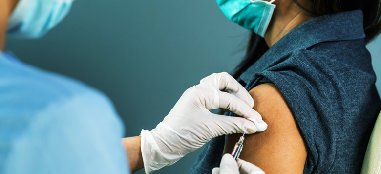 Nurse giving a patient the COVID-19 vaccine.