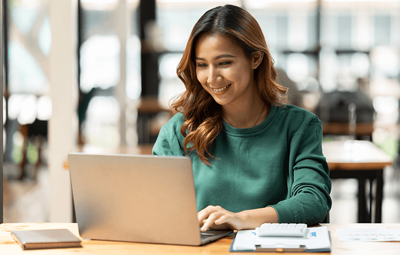 a business student researching on a laptop