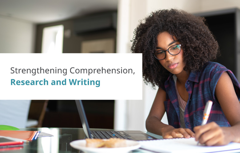 student taking notes at a table