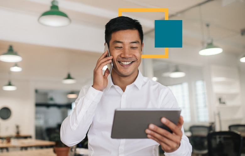 a corporate employee holding a tablet while on the phone