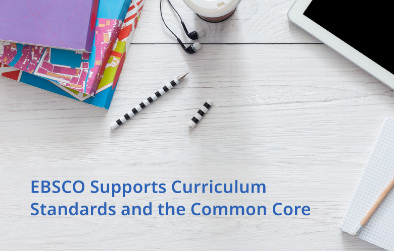 desk with notebooks and tablet on it