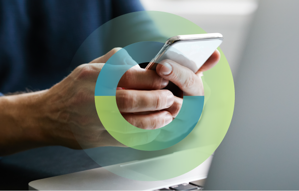 student using phone and laptop