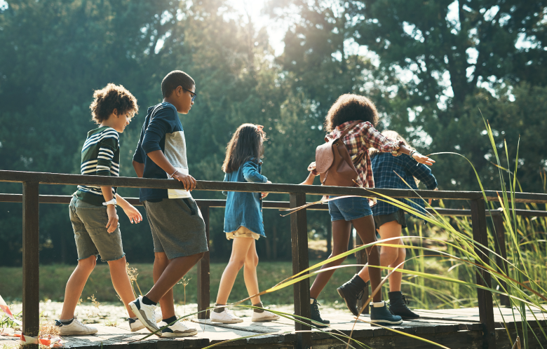 children walking along a footbridge