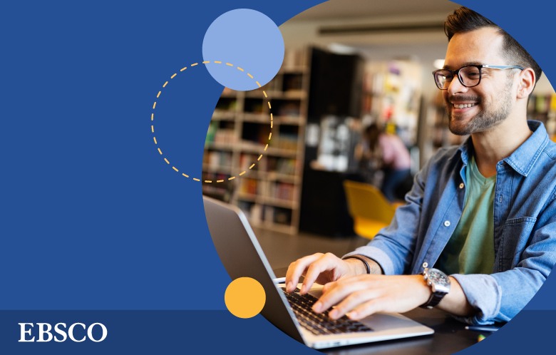 male researcher on laptop in a library