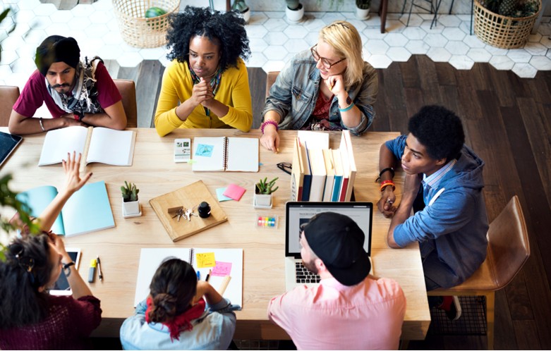 Group of professionals sitting around a table and having a discussion.