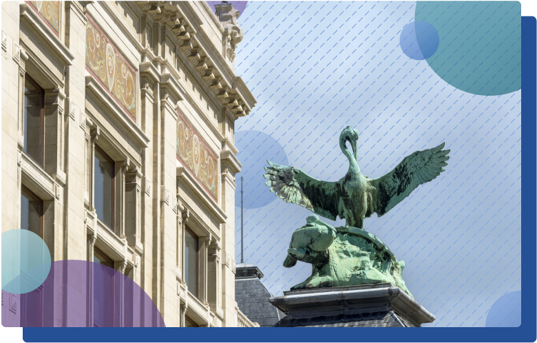 Statue of pelican on a pillar at the Zoo Antwerpen in Belgium, surrounded by colorful shapes and pattern
