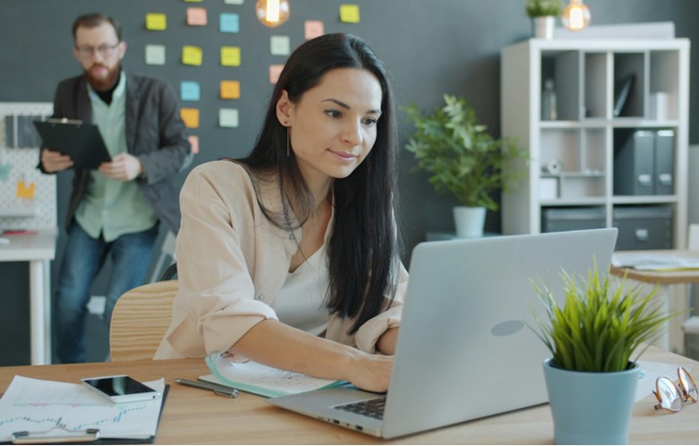 Professional women working on laptop in office