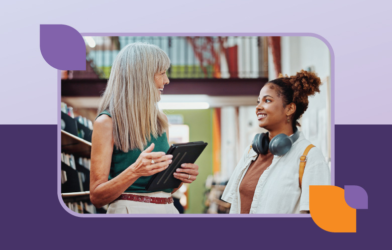Librarian holding a tablet while talking to a woman. 