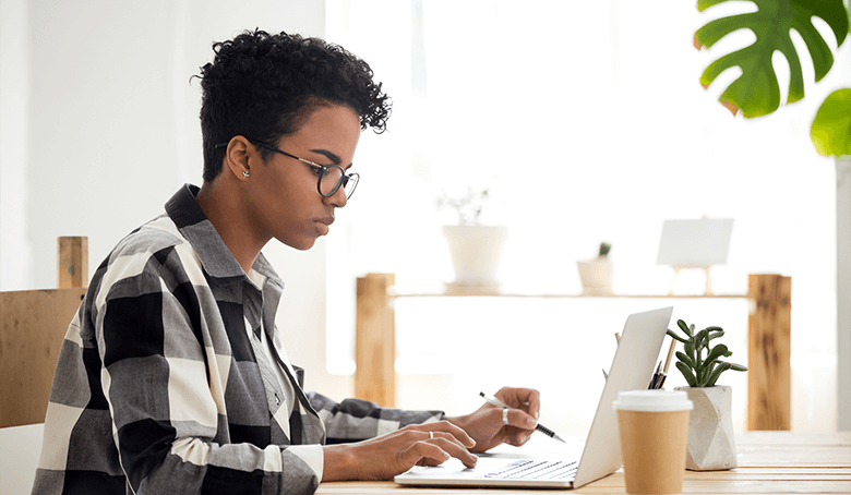 Black woman on laptop in home office