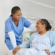 A nurse assisting a patient in a hospital bed