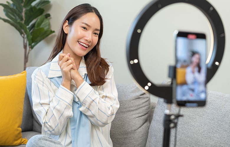 Woman posing for a selfie with a phone stand