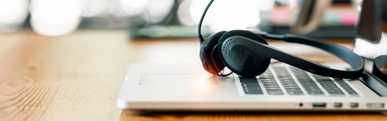 laptop on desk with headset