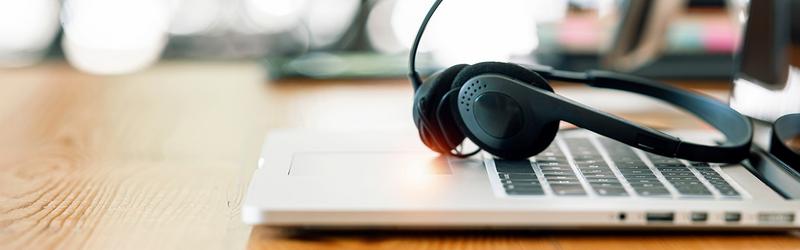 laptop on desk with headset