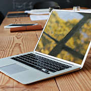 Reflection of window on laptop at conference table