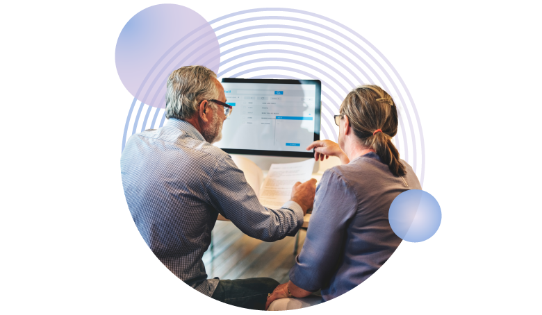 image of two researchers looking at a desktop with circle pattern in the background