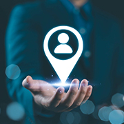 Person holds icon of a location marker with user symbol, target marketing, and customer centric