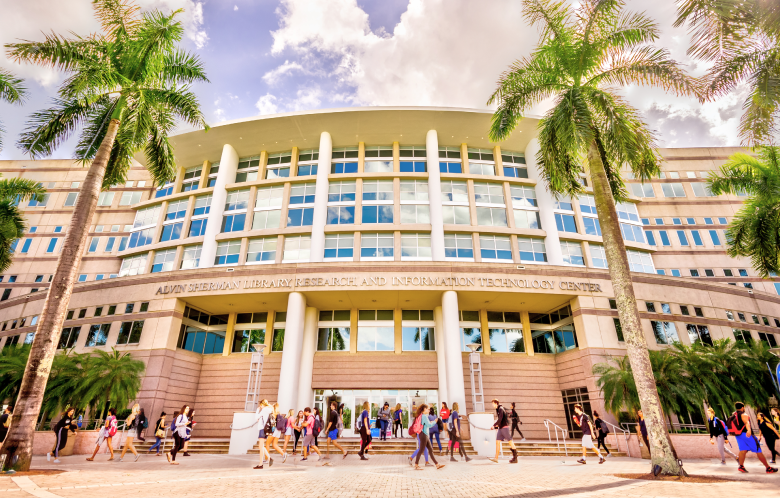 Students walk outside the Alvin Sherman Library, Research, and Information Technology Center at Nova Southeastern University