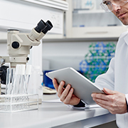 Close up of researcher on tablet in lab setting