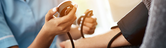 Close up of nurse testing patient's blood pressure