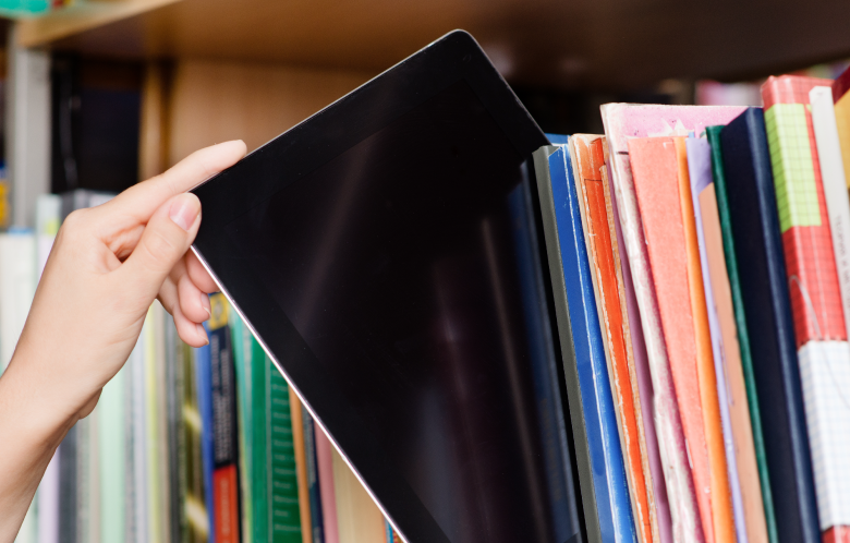 tablet in a shelf with books