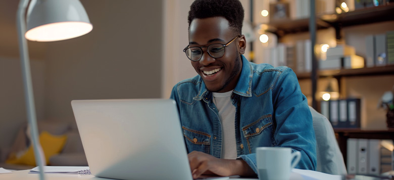 male researcher on laptop in an academic setting 