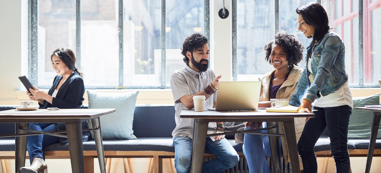Group of people talking and researching at a tablet