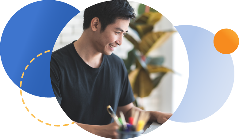 Employee smiling and working at desk