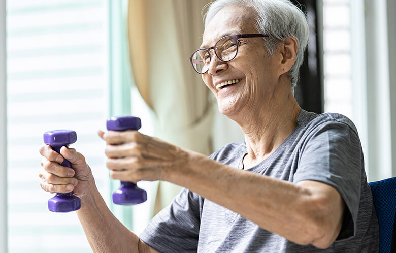 elderly person exercising with dumbbell weights