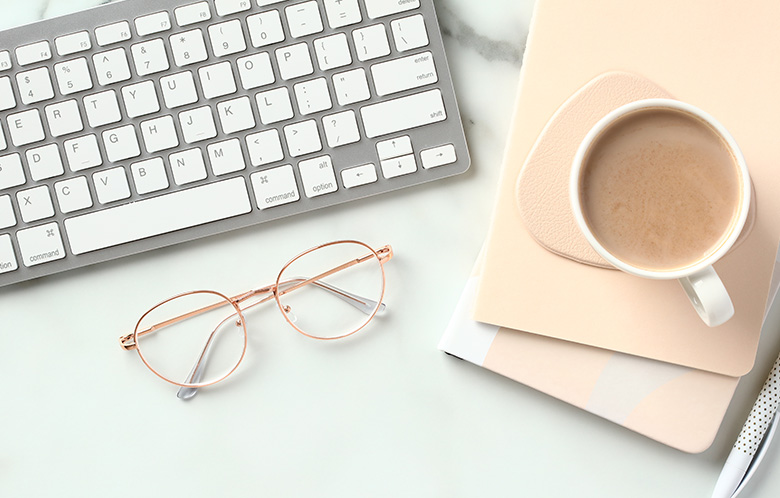 aerial view of Keyboard, glasses, coffee, cup, and notebook