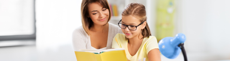 Teacher helping student read.