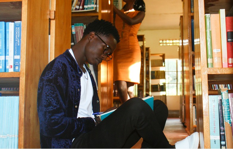 Young man reading in the library