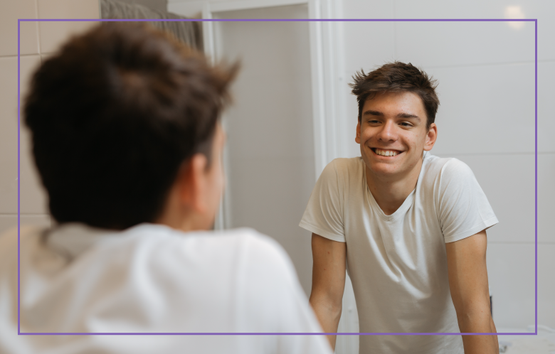 boy smiling looking in the mirror