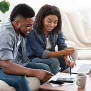 Two people financial planning on a laptop