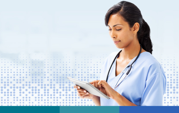 Female nurse wearing stethoscope and reading tablet