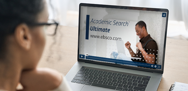 woman watching the academic search ultimate video on her laptop