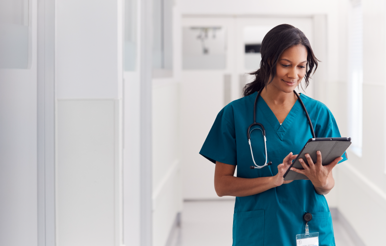 female nurse reading on a tablet in the hospital