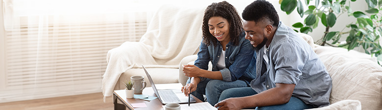 Two people financial planning on a laptop