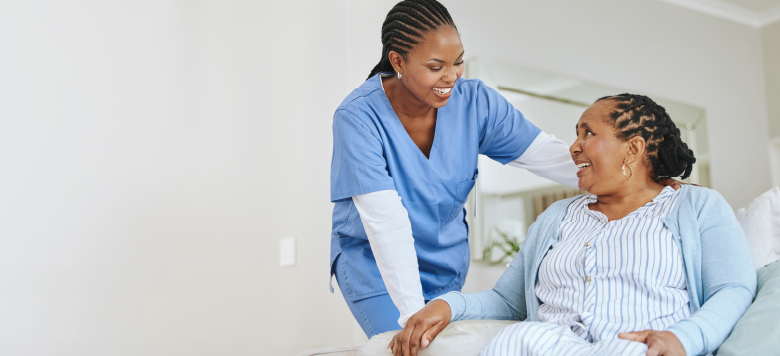 A nurse assisting a patient in a hospital bed