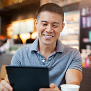 Man using digital tablet in cafe