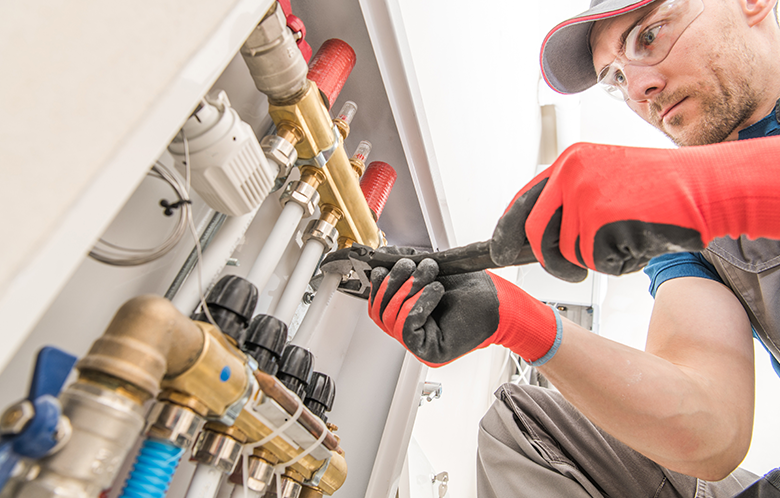 Worker tightening floor heating valves