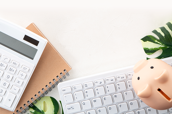 laptop, piggy bank, calculator and notebook