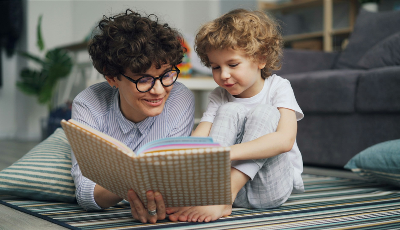 Mother and son reading picture book together